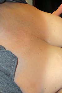 an elder woman lying in a sofa having bang-out