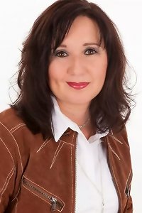 busty blond lady wearing tights and high stilettos taking a spear